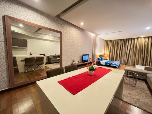 a living room with a dining table and a living room at Regalia Spritz Empire Hostel in Kuala Lumpur