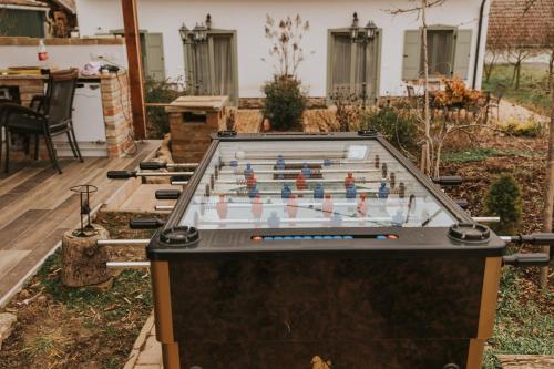 a pool table in a backyard with a chessboard at Neidhardt Vendégház in Bóly