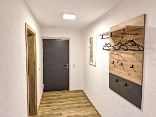 a hallway with a black door and a wooden floor at Apartment Marina by Interhome in Arzl im Pitztal