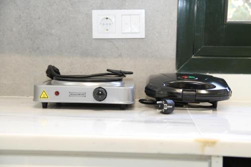a toaster sitting on top of a kitchen counter at Pirgos Warm Studio for 3 by MPS in Pýrgos