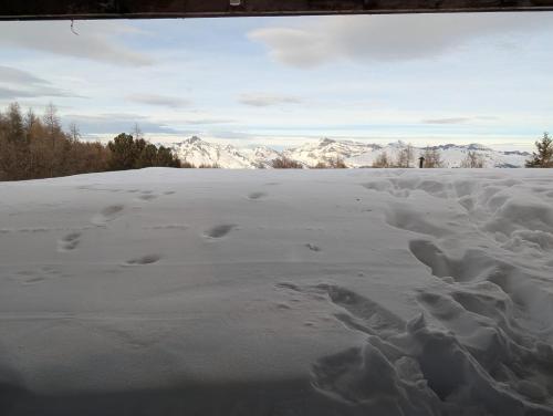 a snow covered field with footprints in the snow at Ski-In, ski-out Thyon in Vex