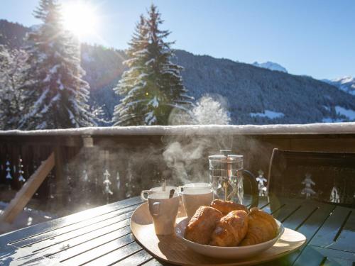 a plate of pastries on a table on a balcony at Chalet Chalet Casablanca by Interhome in Gryon
