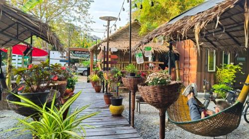 a boy sleeping in a hammock in a flower shop at Do Dee cafe in Bangkok