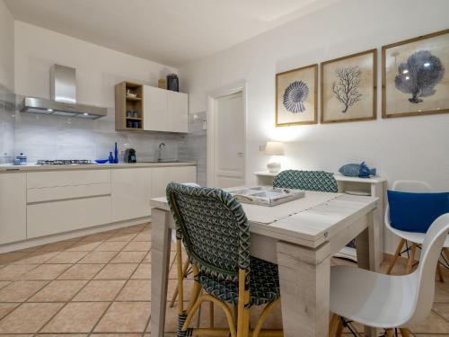 a kitchen with a wooden table and chairs at Apartment La casa dei Cestini by Interhome in Agrustos