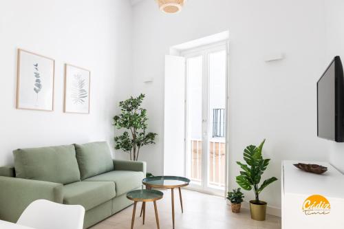 a living room with a couch and a table at Villalobos by Cadiz Time in Cádiz