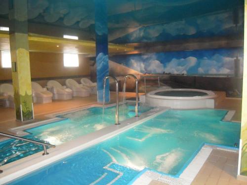 a hot tub in a room with a toilet at Silken Spa La Hacienda De Don Juan in Llanes