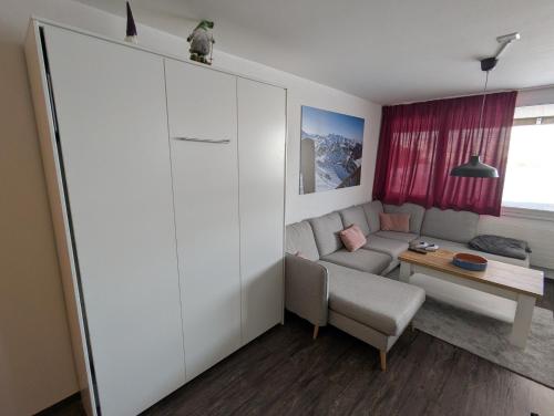 a living room with a couch and a table at Ski-In, ski-out Thyon in Vex