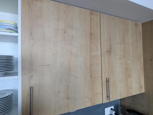 a wooden cabinet in a kitchen with plates at Ski-In, ski-out Thyon in Vex