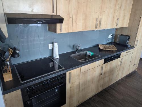 a kitchen with a sink and a stove at Ski-In, ski-out Thyon in Vex