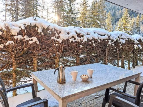 a table with a tea kettle and cups on top at Apartment Arolla R01 by Interhome in Champex