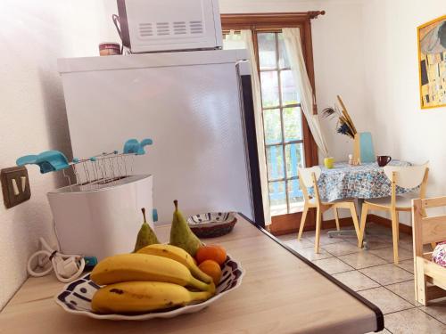 a bowl of bananas and other fruit on a table in a kitchen at Gurbialde Etxea in Mutriku