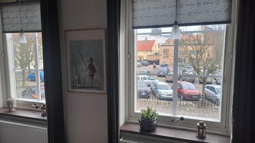 a window with a view of a parking lot at Sveriges minsta Hotell! Hôtel Gruyère in Landskrona