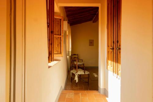 an empty hallway with a chair in a house at Fattoria Poggio Capponi in Montespertoli
