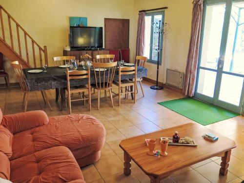 a living room with a couch and a table at Holiday Home Le Pigeonnier by Interhome in Gindou