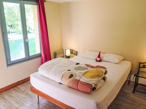 a bedroom with a large bed with a red curtain at Holiday Home Le Pigeonnier by Interhome in Gindou