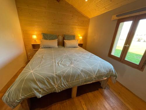 a bedroom with a large bed in a room at Le Clos des 4 Bastides in Saint-Eutrope-de-Born