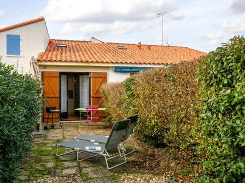 a house with an orange roof and a patio at Holiday Home Plein Océan-4 by Interhome in Pornic
