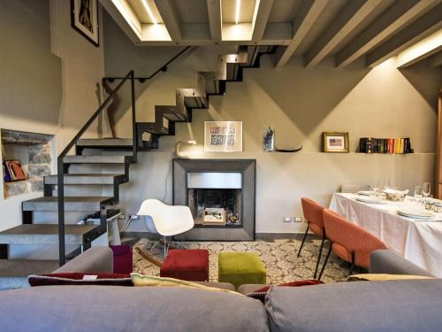 a living room with a staircase and a fireplace at Villa La Casetta sul Lago by Interhome in Clusane sul Lago