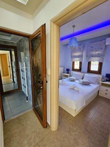 a bedroom with a bed and a walk in shower at Lilian Luxury Villa Halkidiki in Nea Fokea
