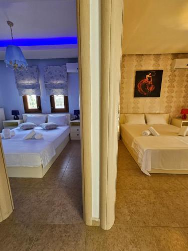 a hotel room with two beds in a room at Lilian Luxury Villa Halkidiki in Nea Fokea