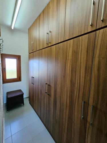 a row of wooden cabinets in a room at Lilian Luxury Villa Halkidiki in Nea Fokea