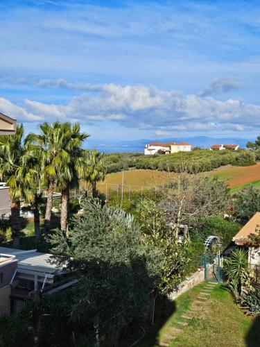 a view from the balcony of a house with palm trees at Lilian Luxury Villa Halkidiki in Nea Fokea