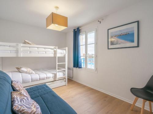 a living room with a couch and a bunk bed at Apartment Les Hautes Folies-9 by Interhome in Vaux-sur-Mer