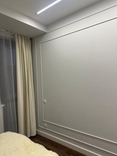 a large screen in a room with a curtain at An hotel in Yerevan