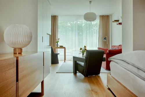 a living room with a couch and a chair at Bellevue Parkhotel & Spa - Relais & Châteaux in Adelboden
