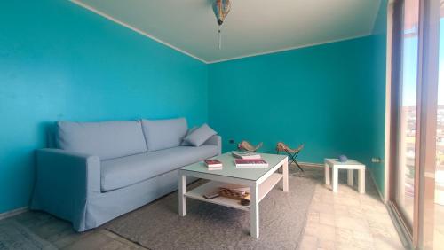 a blue living room with a couch and a table at Hostal Florida Valpo in Valparaíso
