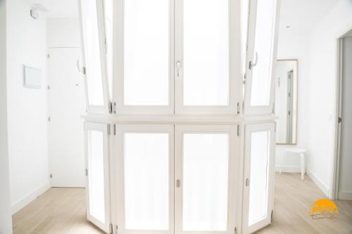 a room with white closet doors in a room at Villalobos by Cadiz Time in Cádiz
