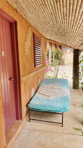 a mattress sitting outside of a building next to a door at LE BENTENIER Home Détente in Nianing