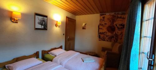 a bedroom with two beds and a window at BnB Claudy et Elizabeth Michellod-Dutheil in Le Châble