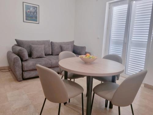 a living room with a table and chairs and a couch at VILLA DORA ZULJANA PELJESAC CROATIA in Žuljana