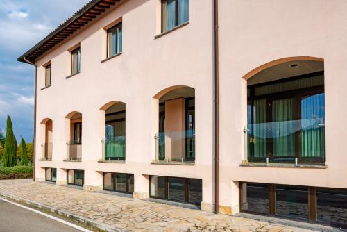 a facade of a building with large windows at Il Gentiluomo Hotel & SPA in Arezzo