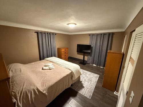 a small bedroom with a bed and a television at The Gather Grove in Toledo