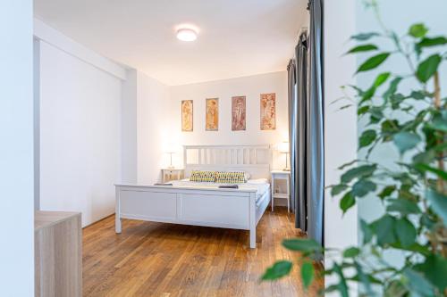 a bedroom with a bed and a desk in a room at Mitte Apartments in Brno