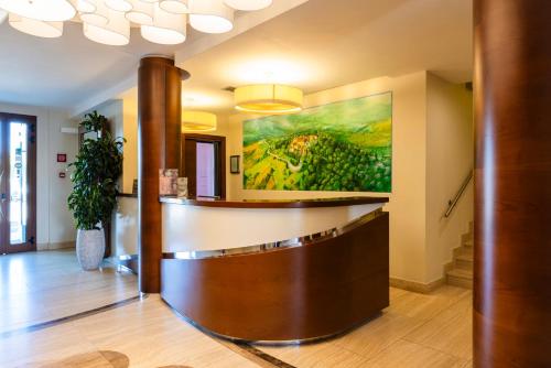 a lobby with a large painting on the wall at Il Gentiluomo Hotel & SPA in Arezzo