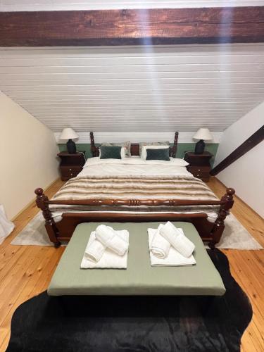 a bedroom with a large bed with two white towels at Vacation house SMEKI in Lokošin Dol