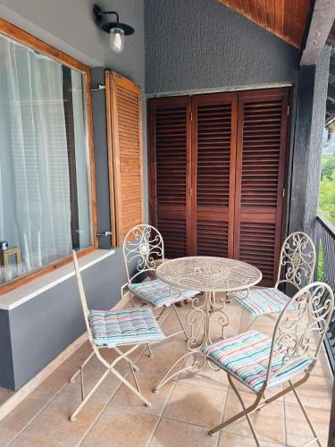 a patio with a table and chairs on a porch at Vacation house SMEKI in Lokošin Dol