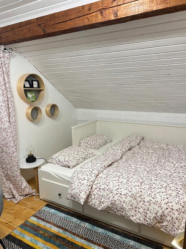 a bedroom with two beds and a wooden ceiling at Vacation house SMEKI in Lokošin Dol