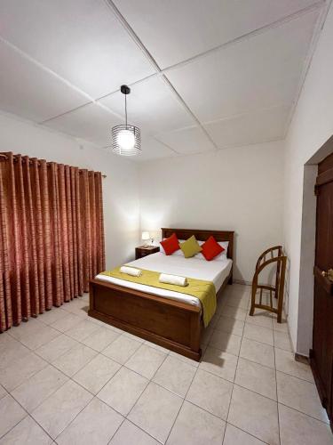 a bedroom with a bed and a chair in it at Villa Bianca in Kegalle