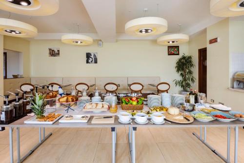 a table with a bunch of food on it at Il Gentiluomo Hotel & SPA in Arezzo