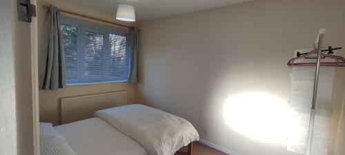a small bedroom with a bed and a window at Sheffield Arena Meadowhall Interchange with off road free parking & CCTV in Sheffield
