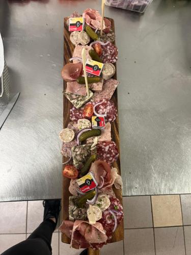 a row of different types of food on a counter at Le Clos Joli in Haybes