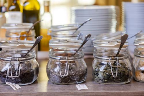 a group of jars of pickles on a table at Il Gentiluomo Hotel & SPA in Arezzo