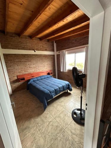 a bedroom with a bed and a desk in a room at Complejo Puesta del Sol san Luis in La Punta
