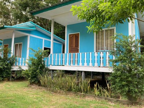 a blue house with a porch in front of it at Baan seefa homestay kohyaoyai in Ko Yao Yai