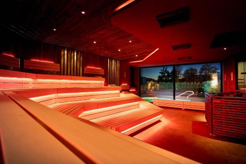 a room with rows of seats in front of a large screen at Hotel Panorama Royal in Bad Häring