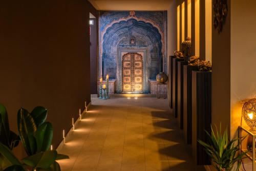a hallway with a door with candles and plants at Il Gentiluomo Hotel & SPA in Arezzo